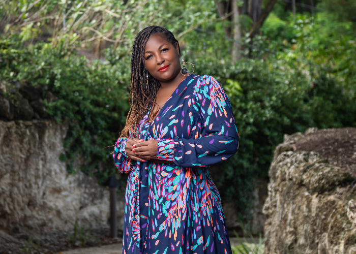 Woman in dreadlocks wearing a blue dress